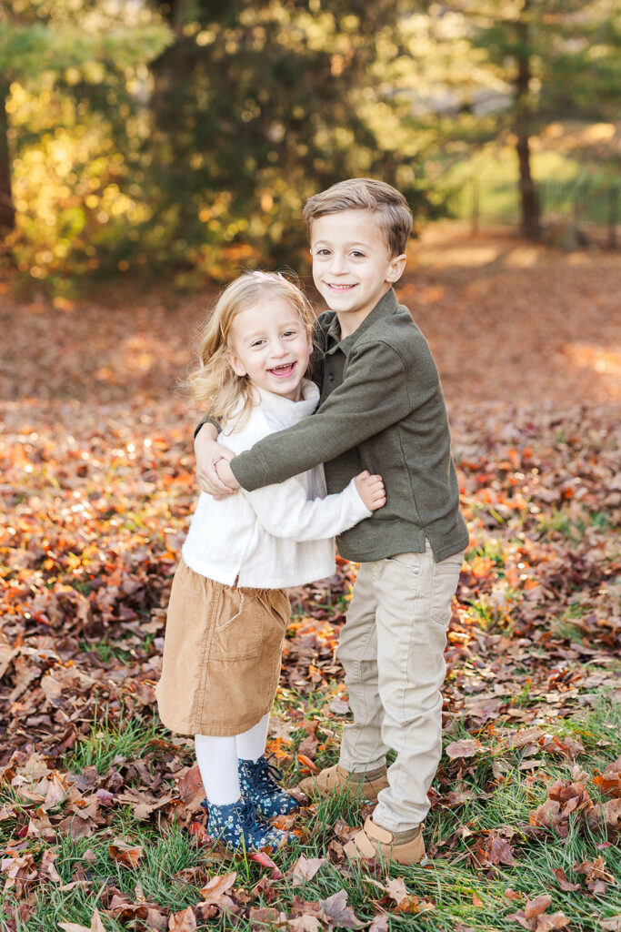 a brother and sister hugging during a mini session