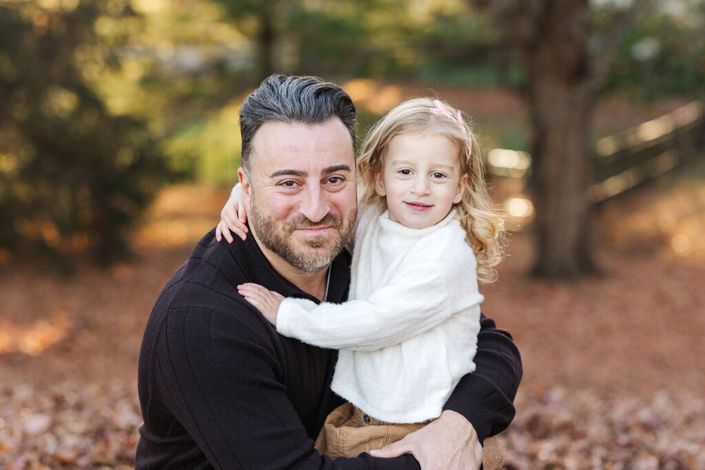 A father holding his daughter during a mini-session
