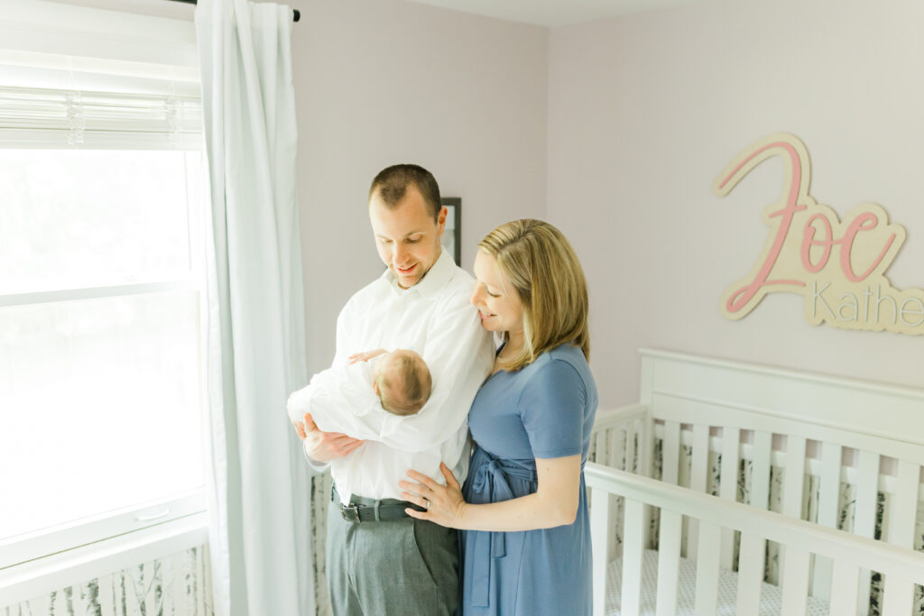 a mom and dad looking at their baby