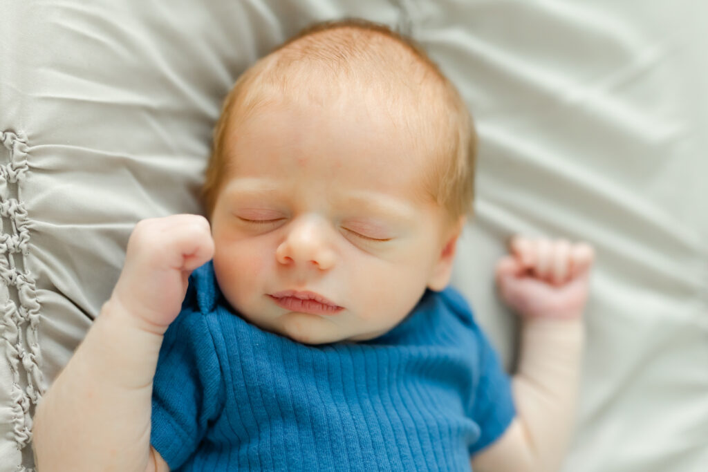 a baby boy sleeping on a bed
