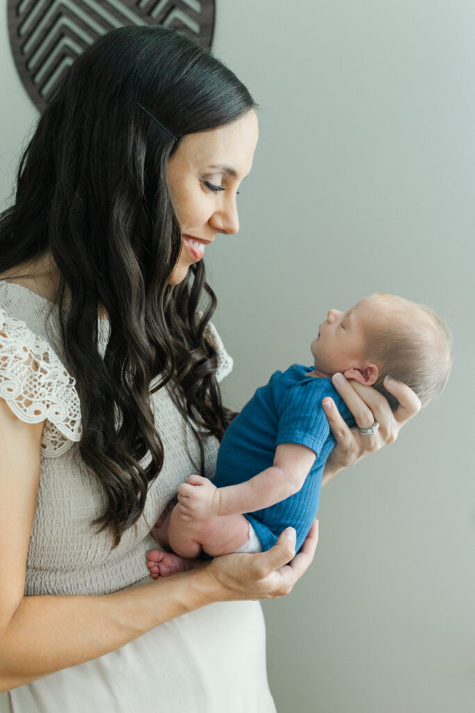 a mom holding her newborn baby 
