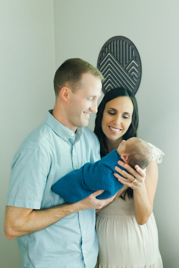 a mom and dad looking at their newborn baby boy